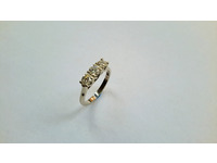 White gold three stone ring with crossover sides to bezel.