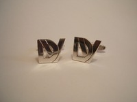Silver cufflinks cut out with DV logo