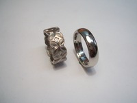 Palladium wedding rings. His traditional court shape. Hers beaded flower design set with Princess cut diamonds