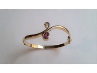 Gold bangle set with one diamond, and one teardrop ruby.Made from old gold.