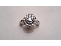 Platinum diamond cluster ring in b=rubover setting, with scallop edge.