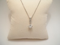 18ct white gold necklet set with a Princess cut diamond, and round brilliant cuts.