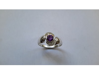 Cluster ring set with centre amethyst and brilliant cut diamonds around in a pavé setting