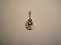 9ct yellow and white gold pendant set with tear drop ruby and diamonds around edge