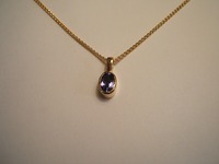 Tanzanite set in 18ct yellow gold on 18ct spiga chain