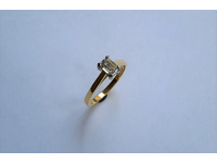 Single emerald cut diamond in a claw setting